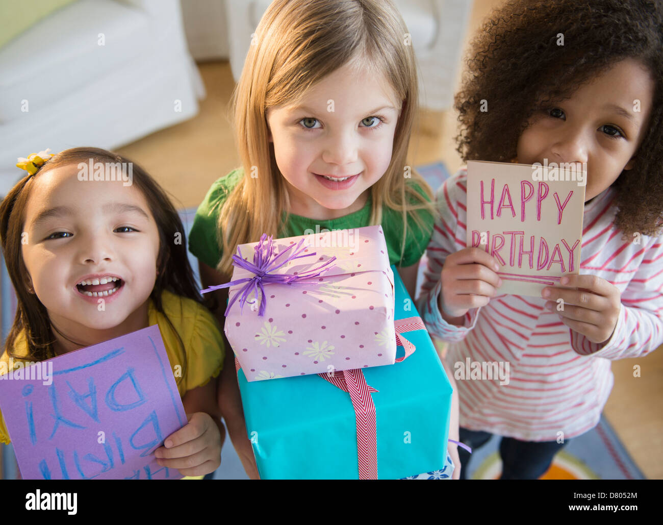 Girls holding presents et cartes at Birthday party Banque D'Images