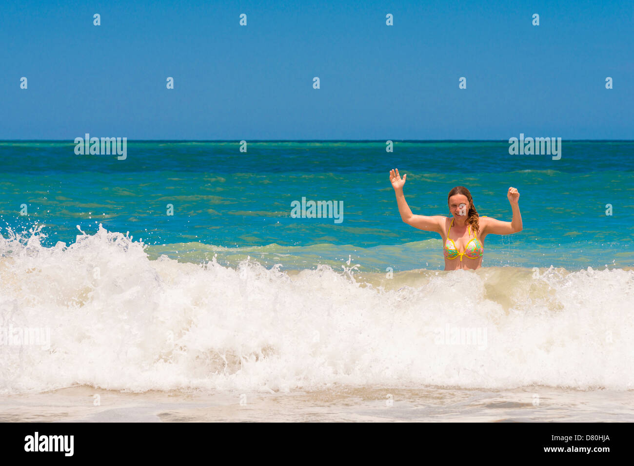 Femme de race blanche de 45 ans bénéficiant d'éclabousser et de plaisir de l'eau à une plage de la Floride Banque D'Images