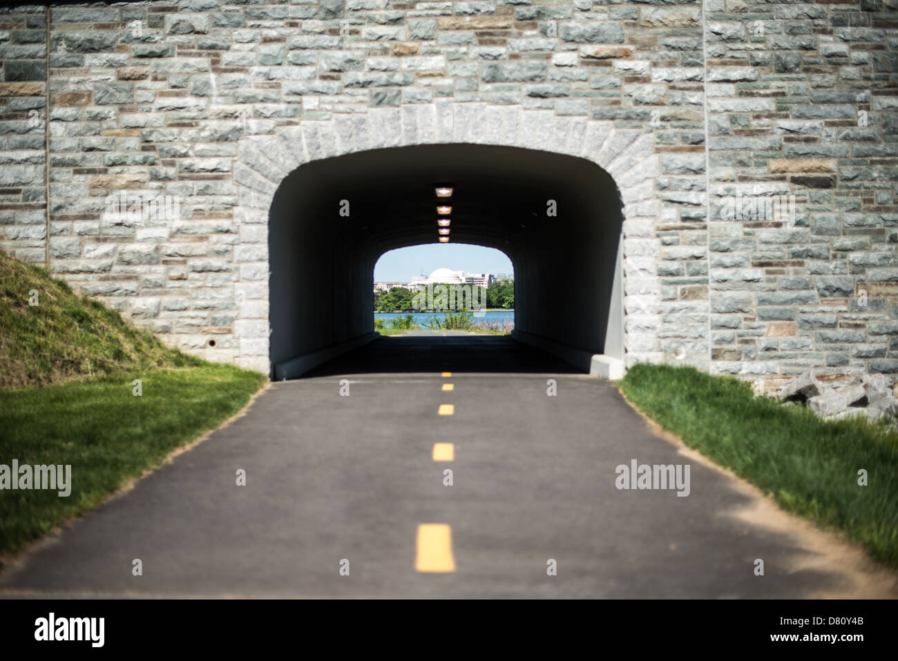 WASHINGTON DC, États-Unis — en regardant à travers un tunnel piétonnier et cycliste à travers un nouveau pont de pierre George Washington Memorial Parkway reliant l'île Columbia au continent. Au loin, à travers le tunnel, se trouve le dôme distinctif du Jefferson Memorial de l'autre côté du Potomac. Banque D'Images