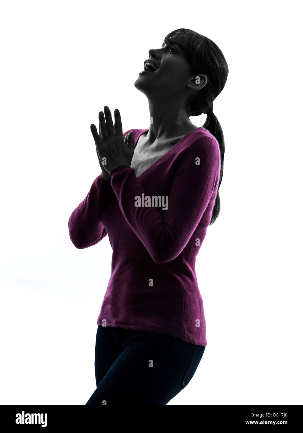 Une femme surprise à la silhouette en portrait de studio isolé sur fond blanc Banque D'Images