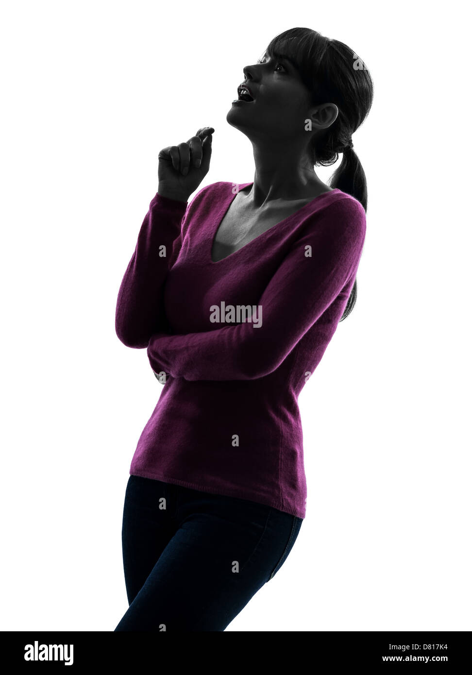 Une femme surprise à la silhouette en portrait de studio isolé sur fond blanc Banque D'Images