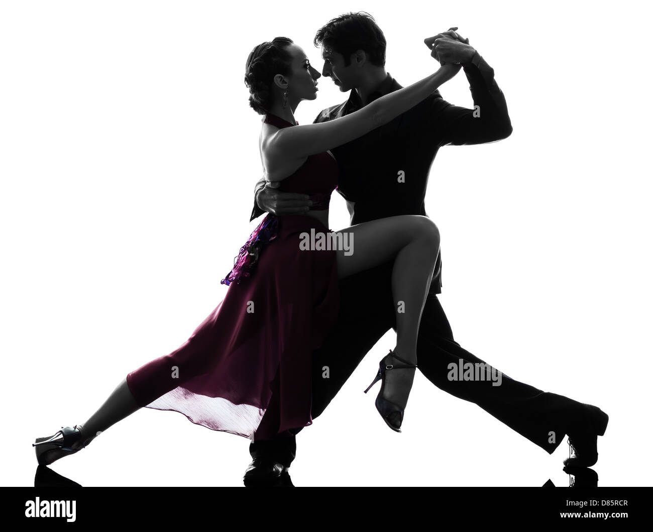 Un couple homme femme ballroom dancers laughing en silhouette studio isolé sur fond blanc Banque D'Images