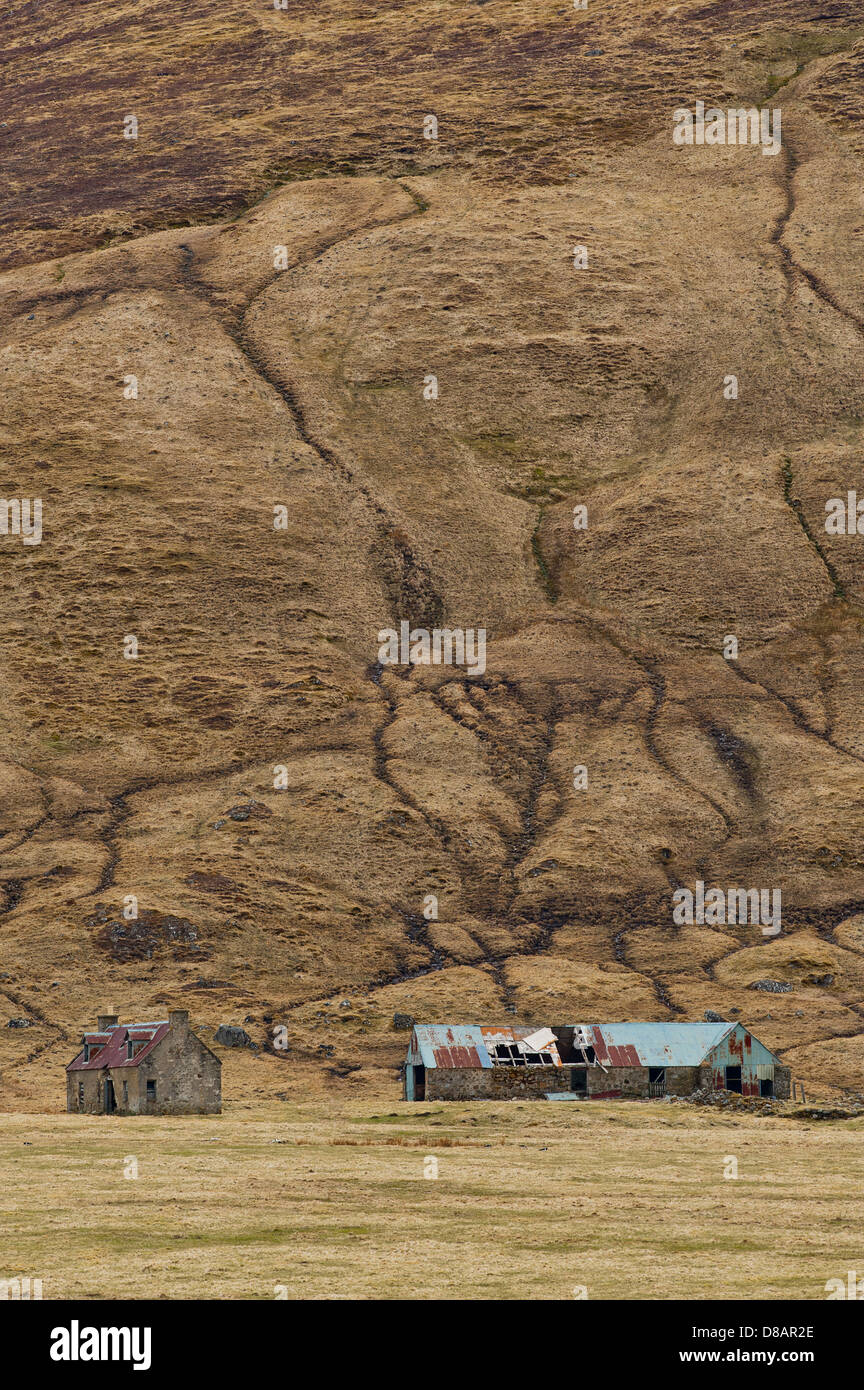 Ferme et grange délabrée au bas de la colline escarpée de la vallée à Findhorn, en Écosse. Banque D'Images
