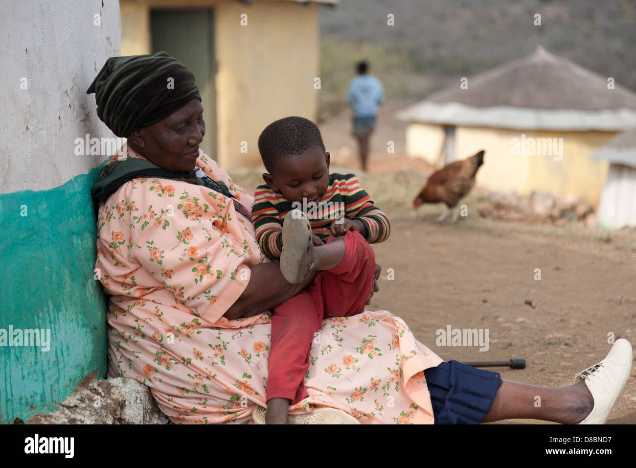 Une vieille femme africaine avec un bâton de marche un enfant confort Banque D'Images