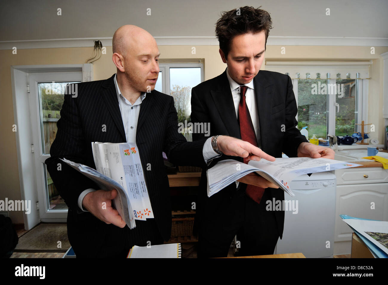Ingénieur en énergie Nigel Banks (à droite) avec Mark Sopala arpenteur de l'énergie les factures d'examen pendant les calculs pour l'optimum il Banque D'Images