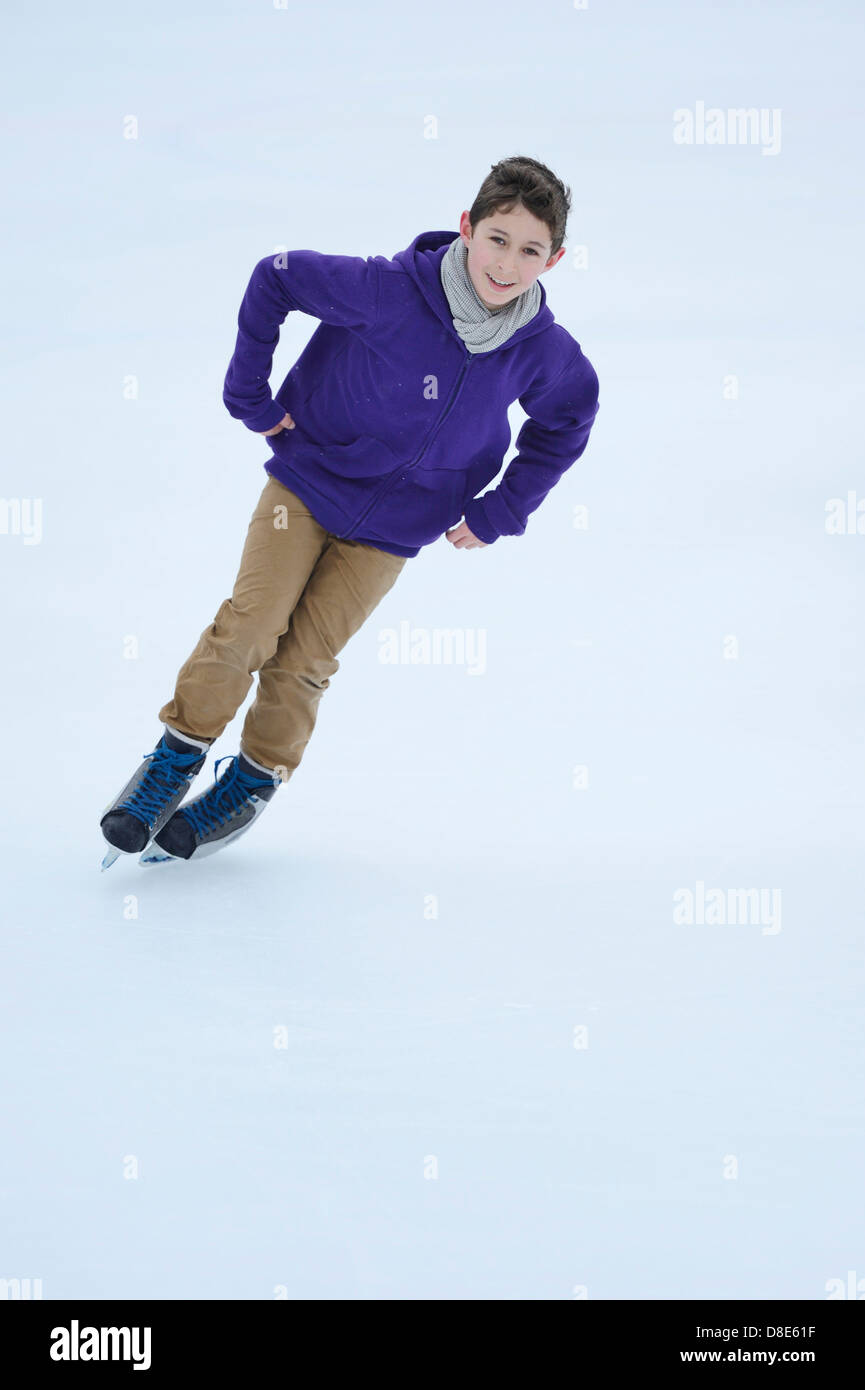 Boy le patin à glace sur un lac gelé Banque D'Images