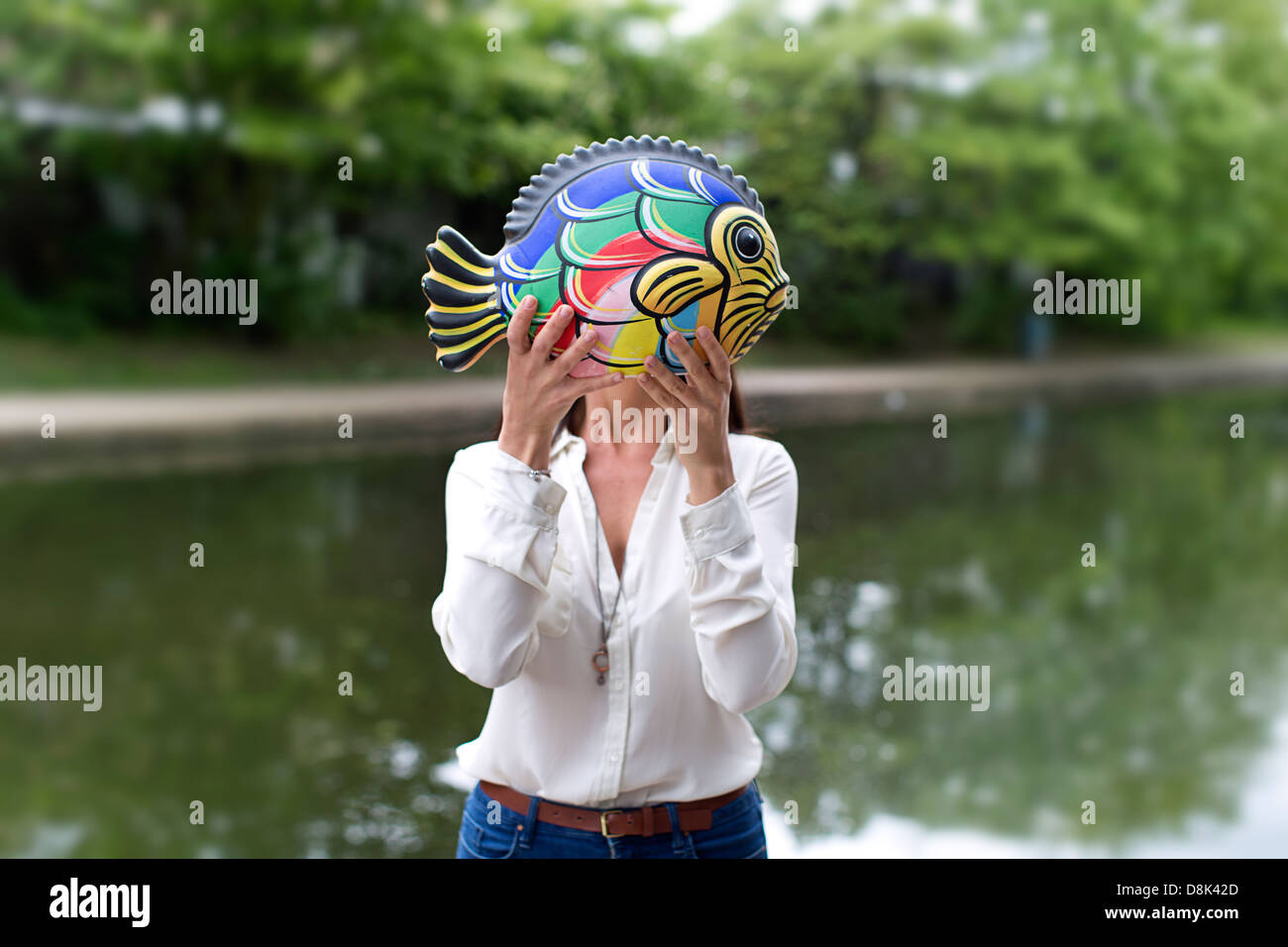 Une fille avec un poisson en céramique Banque D'Images