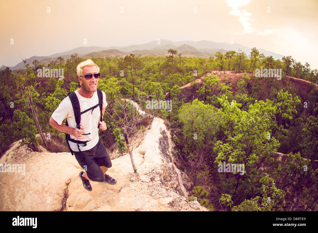 Male hiker en chemise blanche et son sac à dos à marcher le long du chemin de montagne étroit canyon à Pai Thaïlande Banque D'Images