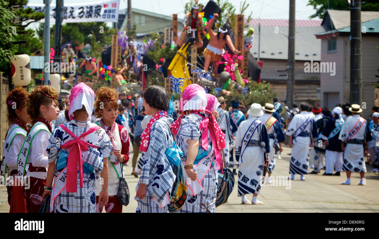 Un groupe de jeunes filles japonaises en Yukata debout autour d'une causerie de note durant le festival d'été. Ils sont les participants. Banque D'Images