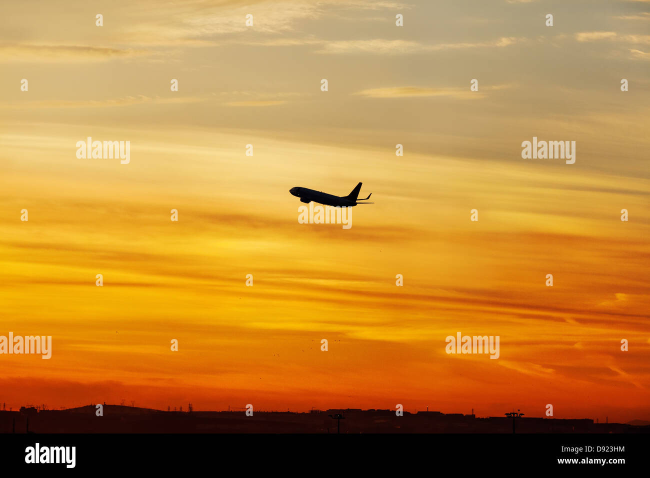 Vol d'un avion au-dessus de la mer au coucher du soleil tropical Banque D'Images