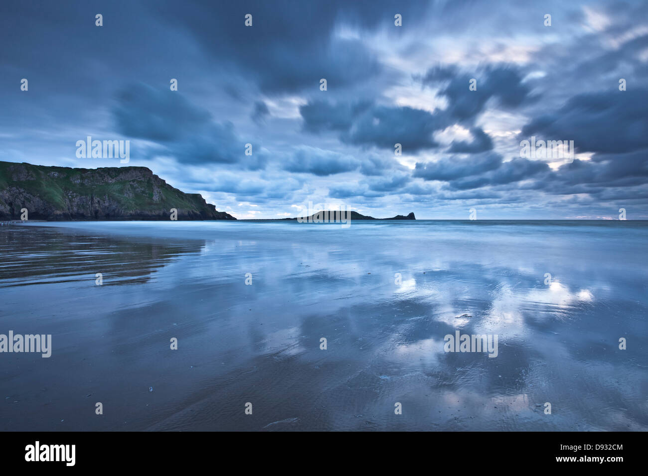 Le soir lumière chatoyante sur le sable humide de Rhossili Bay au Pays de Galles. Banque D'Images
