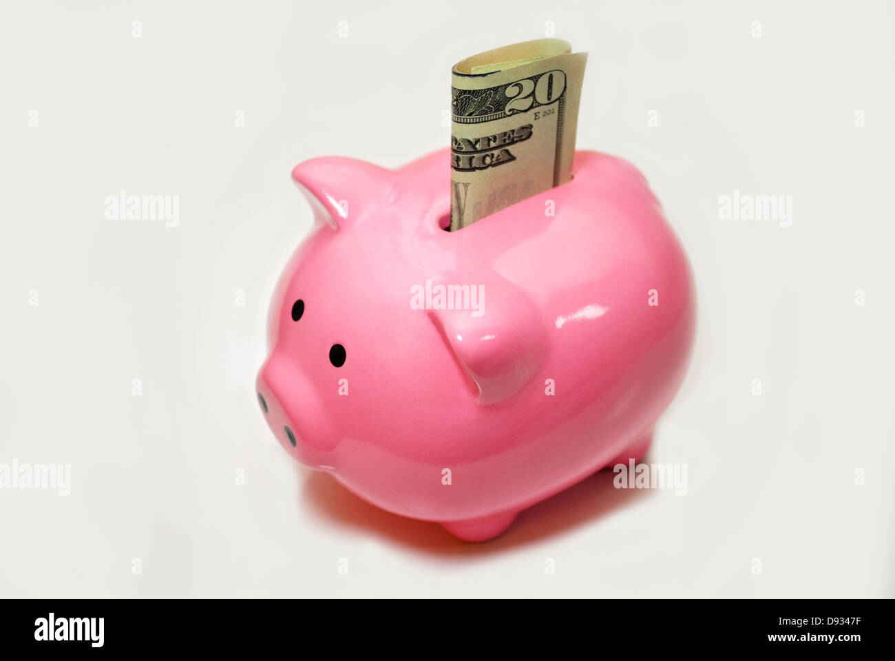 Pink Piggybank avec un $20 Bill Sticking Out Banque D'Images