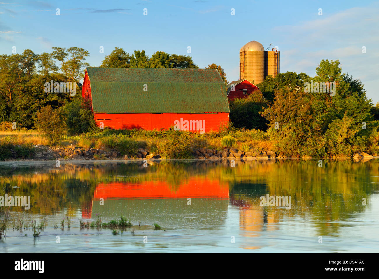 Le vieillissement de la grange rouge reflétée dans le lac Gibson hydro navigable contrôlé à l'aube Thorold Ontario Canada Banque D'Images