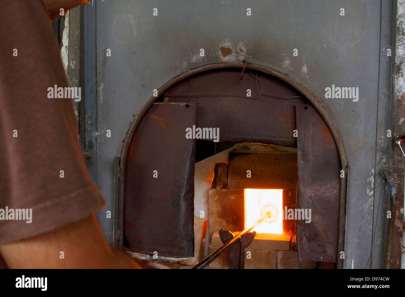 Fusion de verre par un souffleur de verre brillant dans une fabrication. Banque D'Images