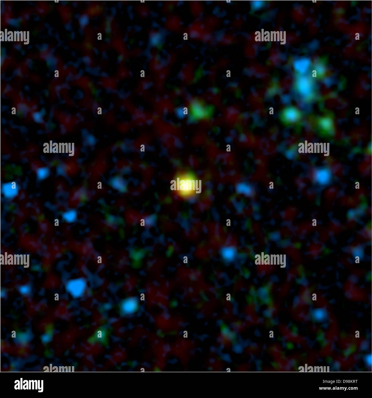 Cette image en fausses couleurs du télescope spatial Spitzer de la NASA montre une galaxie éloignée (jaune) qui abrite un quasar, un Banque D'Images