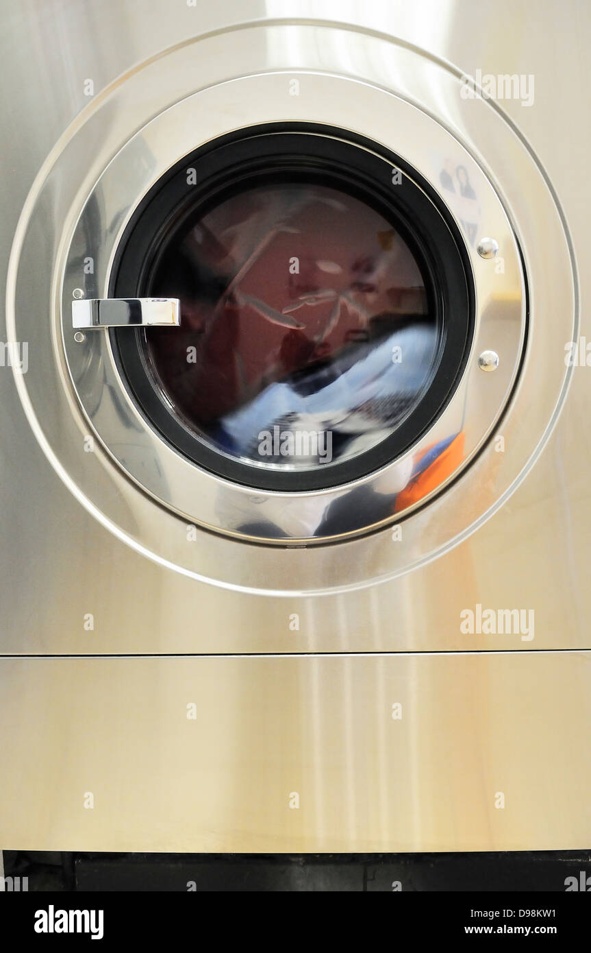 Une rangée de machines à laver industrielles dans une laverie publique Banque D'Images
