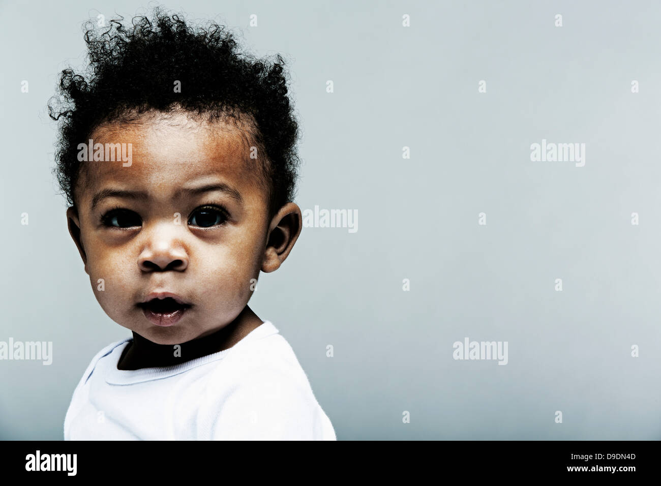 Portrait of baby boy wearing white looking at camera Banque D'Images