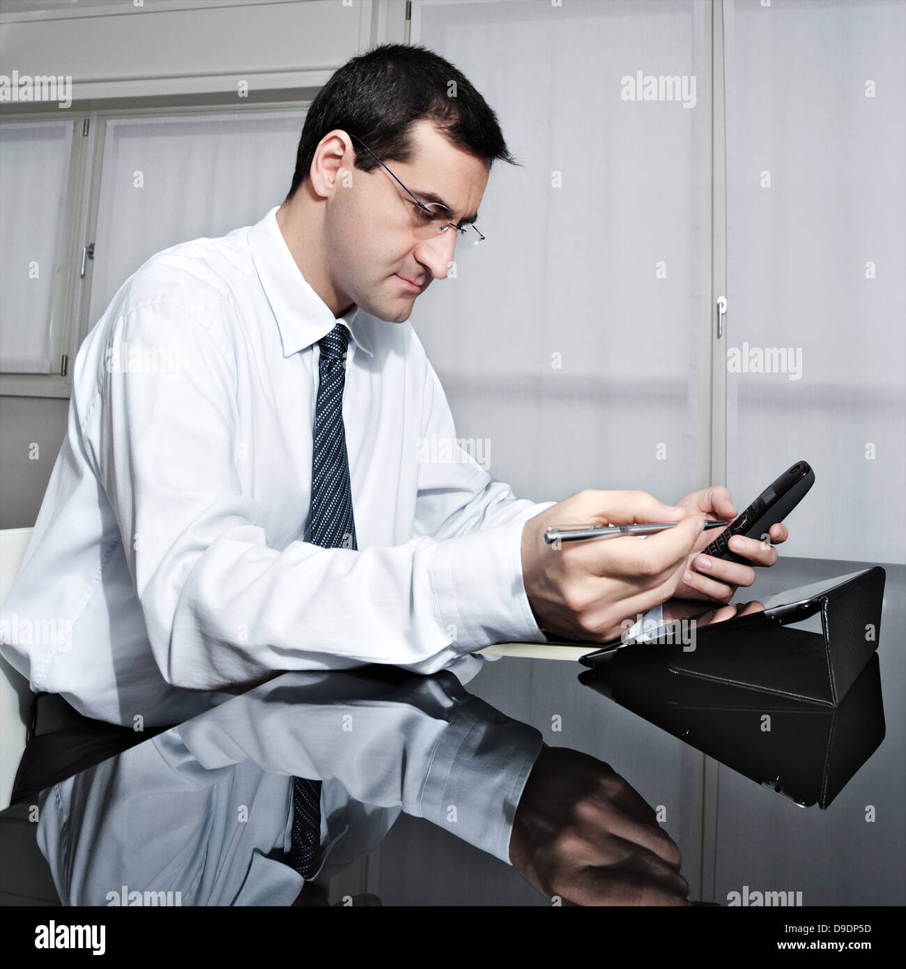 Mature businessman composant téléphone au bureau Banque D'Images