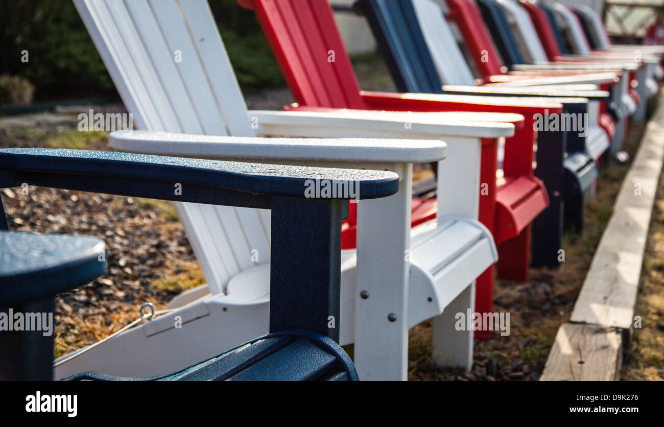 Chaises Adirondack en rouge, blanc et bleu pour le quatrième de juillet d'artifice. Banque D'Images