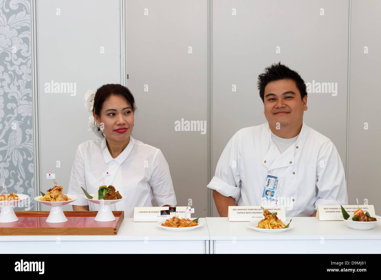 Londres, Royaume-Uni. 22 juin 2013. Goût de Londres 2013. Le personnel de Thai Square Restaurant à le goût de la Thaïlande afficher offrent aux visiteurs leur menu d'échantillonneur. L'événement a lieu chaque année au Regents Park, où 40 des meilleurs restaurants de la ville de servir leurs meilleurs plats pour les visiteurs de l'échantillon. Londres, Royaume-Uni. 22 juin 2013. Photo : Paul Maguire/Alamy Live News Banque D'Images