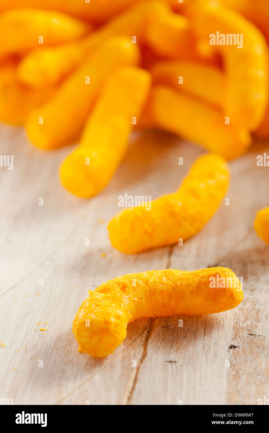 Chips Fromage Puffy Orange malsaine contre un arrière-plan Banque D'Images