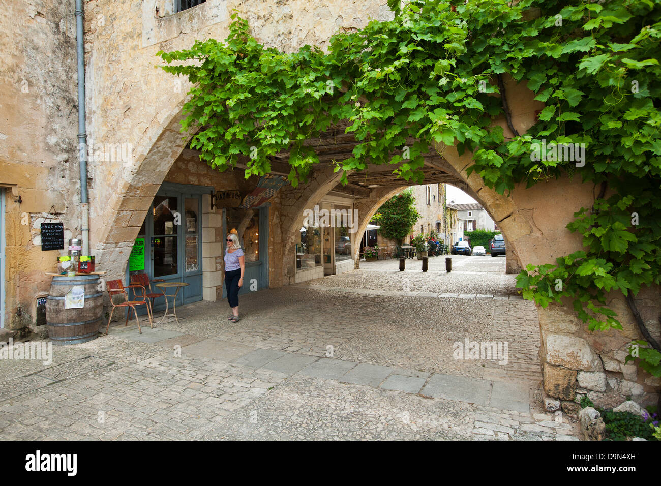 L'un des nombreux des arcs avec boutiques et cafés autour de la Place des cornieres à Monpazier, Dordogne, France Banque D'Images