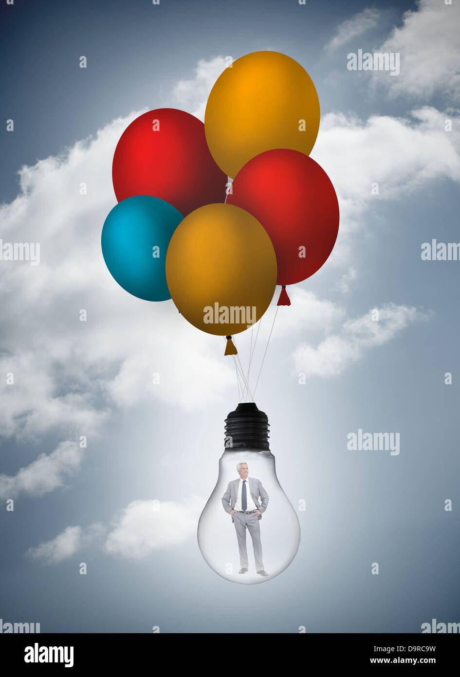 Businessman inside Light bulb tenu par des ballons Banque D'Images Businessman inside Light bulb tenu par des ballons Banque D'Images