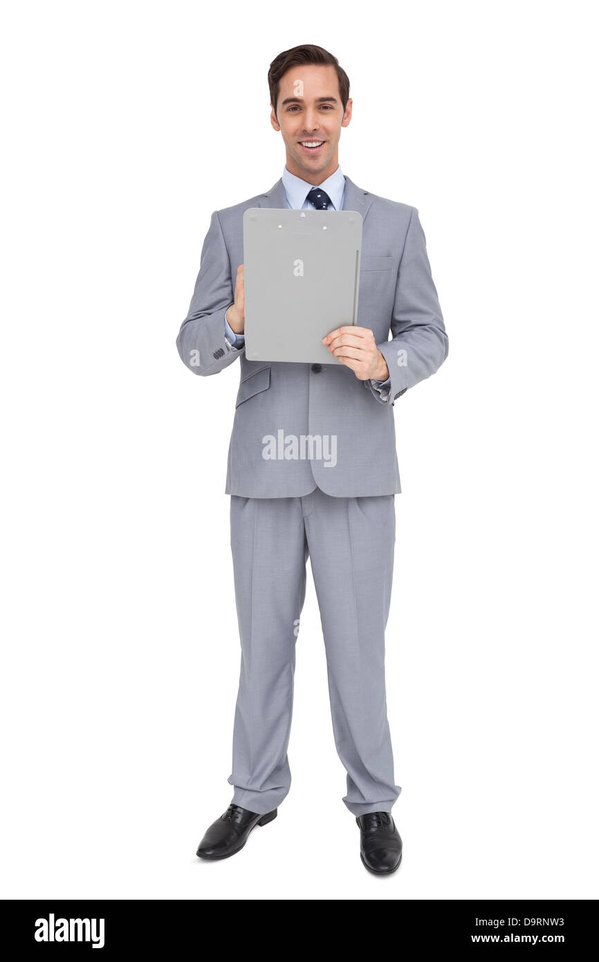 Smiling businessman holding un presse-papiers Banque D'Images