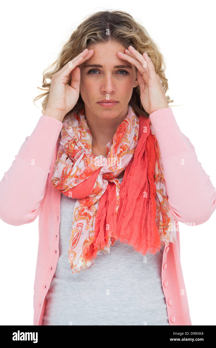 Blonde woman touching her temples en raison d'un mal de tête Banque D'Images