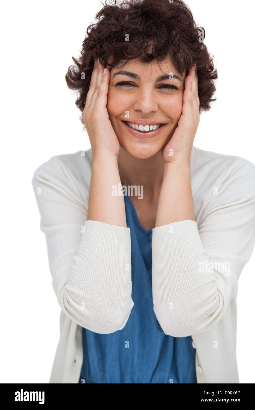 Surpris brunette woman holding sa tête entre les mains Banque D'Images