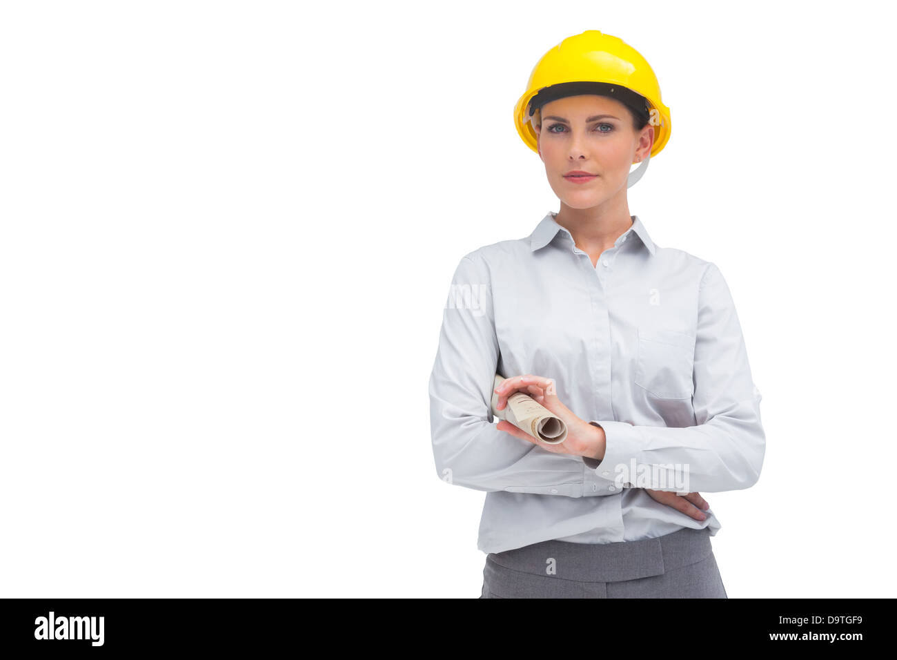 Architecte avec casque jaune et plan enroulé Banque D'Images