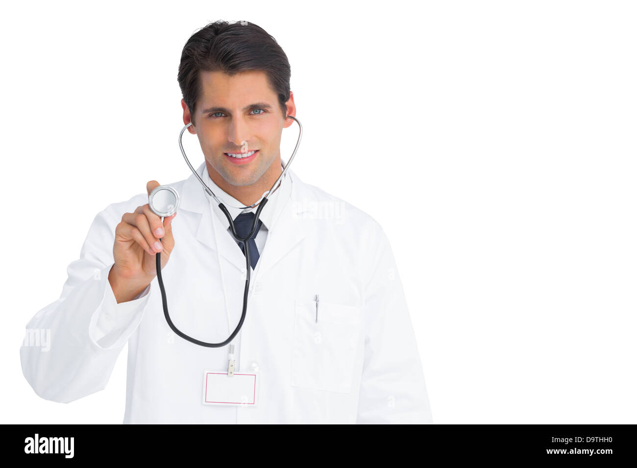 Happy doctor holding up stethoscope Banque D'Images