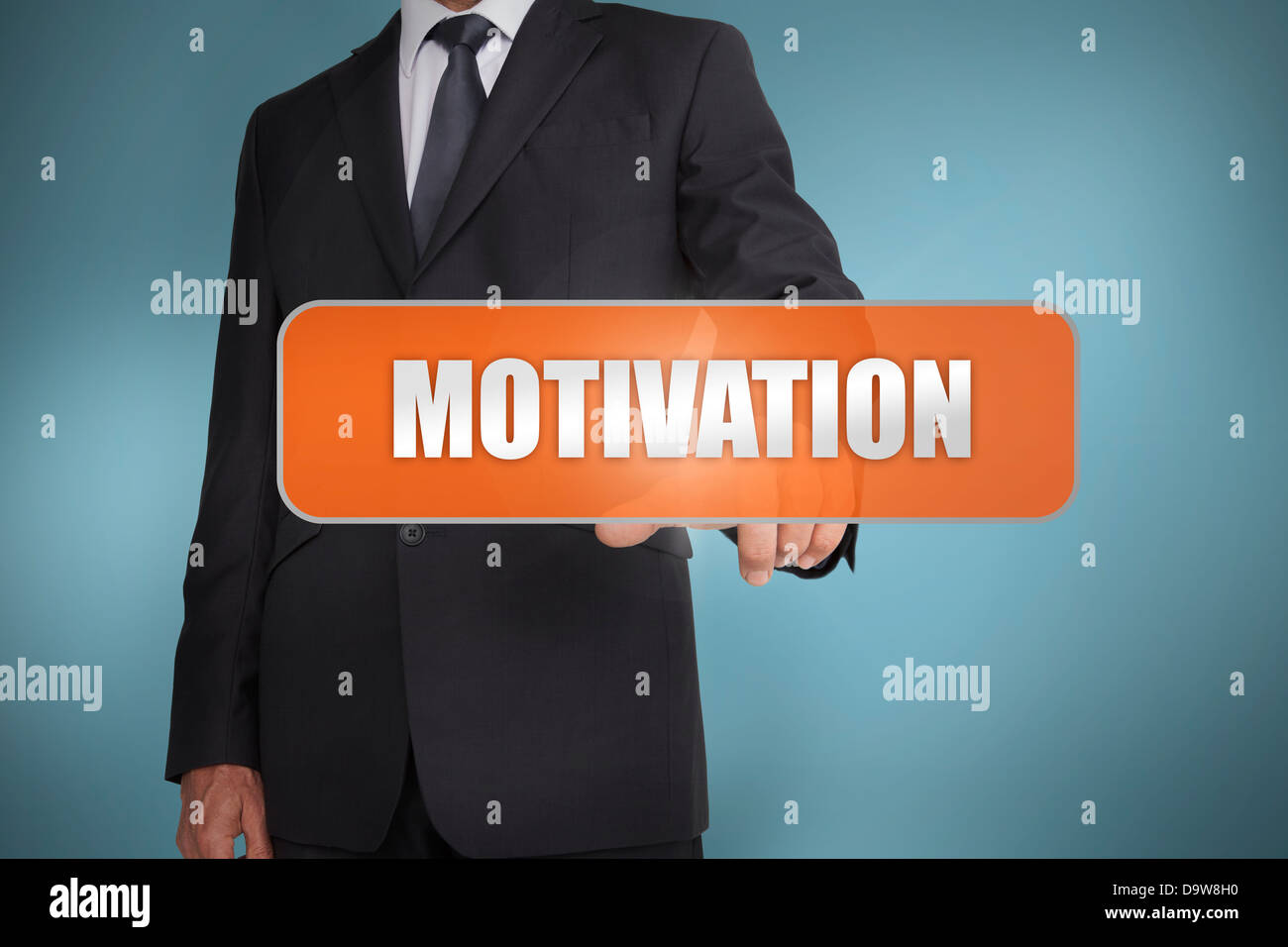 Businessman selecting the word motivation written on orange tag Banque D'Images