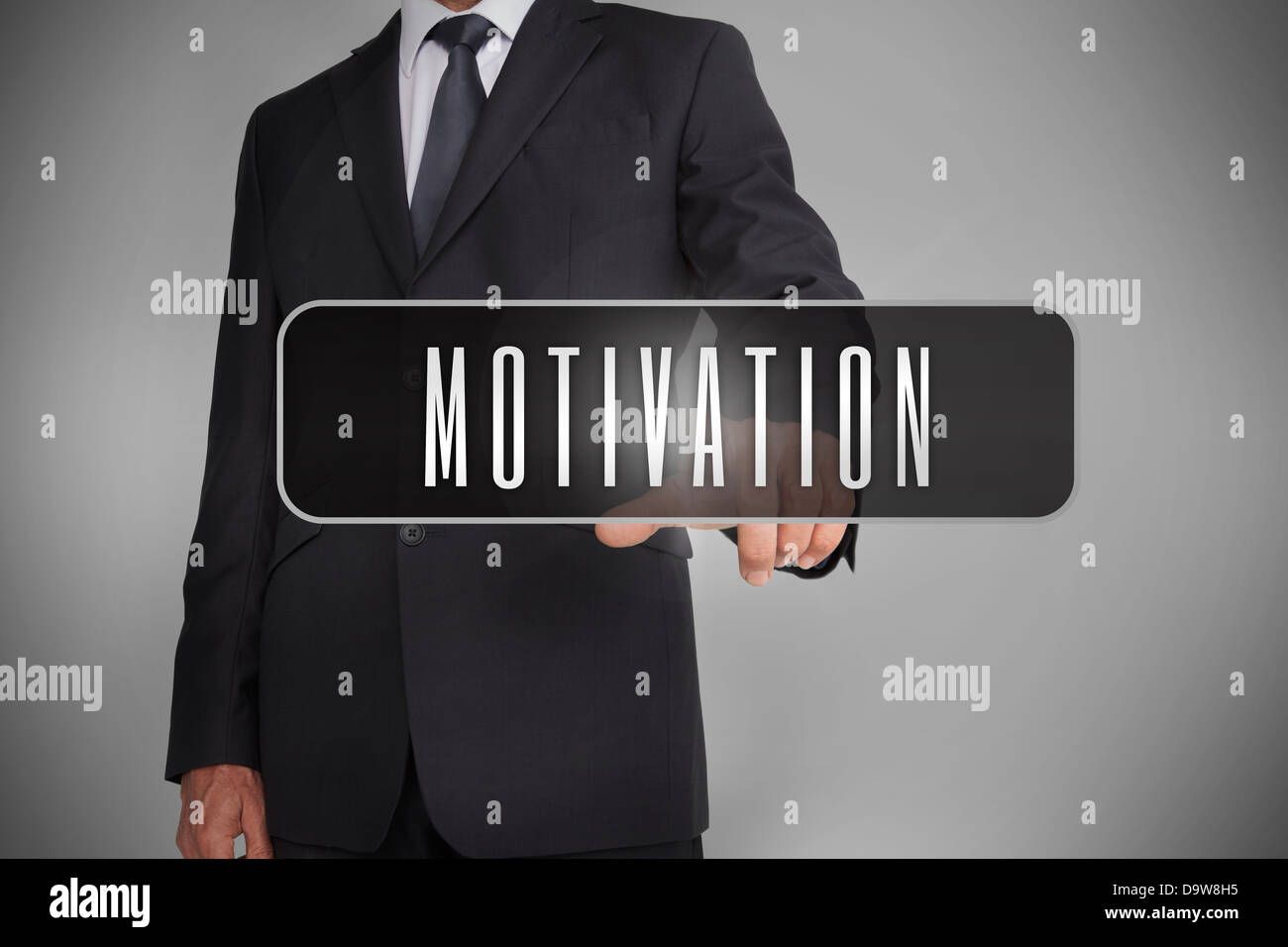 Businessman selecting the word motivation written on black tag Banque D'Images
