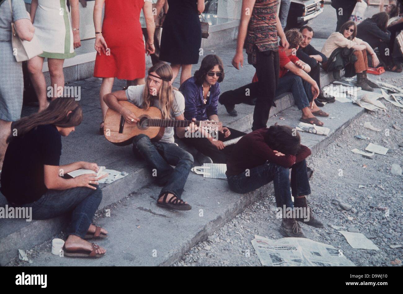 Les hippies s'asseoir sur le trottoir dans la rue Léopold à Munich (photo non datée du début des années 70). Banque D'Images