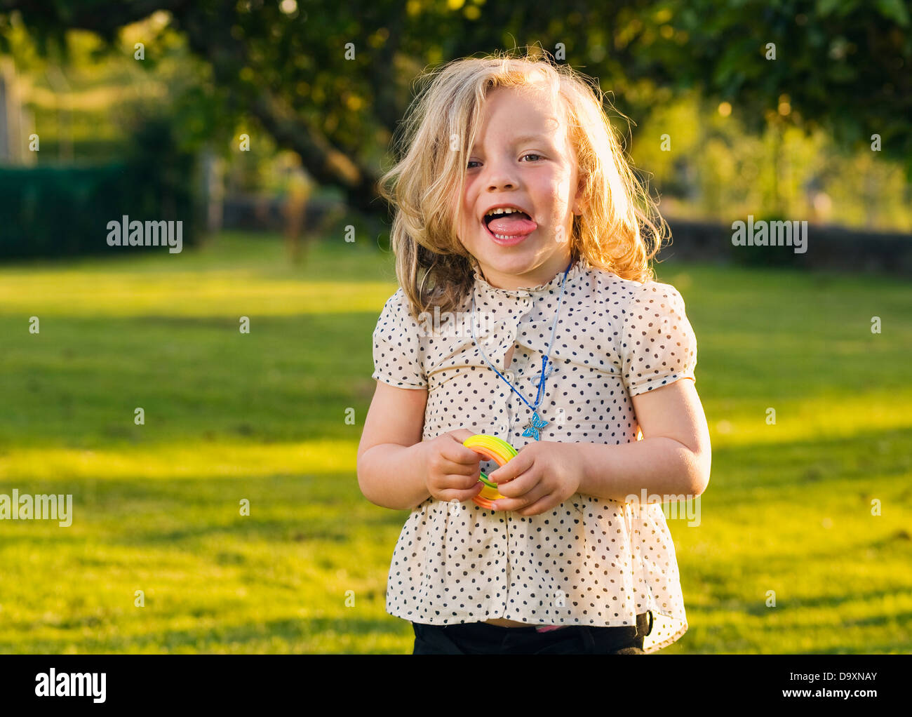 Petite fille avec expression. La fille est coller sa langue et son