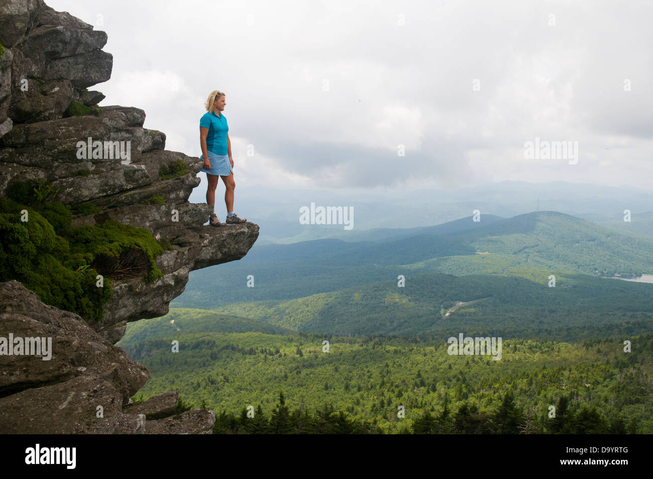 Une femme à la recherche au niveau de la vue sur une pointe rocheuse, Grandfather Mountain State Park, Linville, Caroline du Nord. Banque D'Images