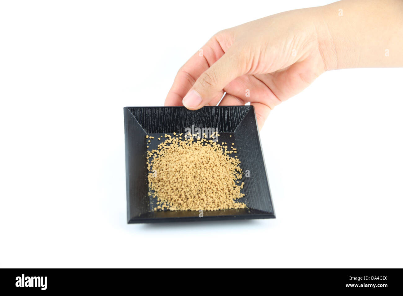 Sont capturés à la main une assiette de gingembre en poudre sur fond blanc. Banque D'Images