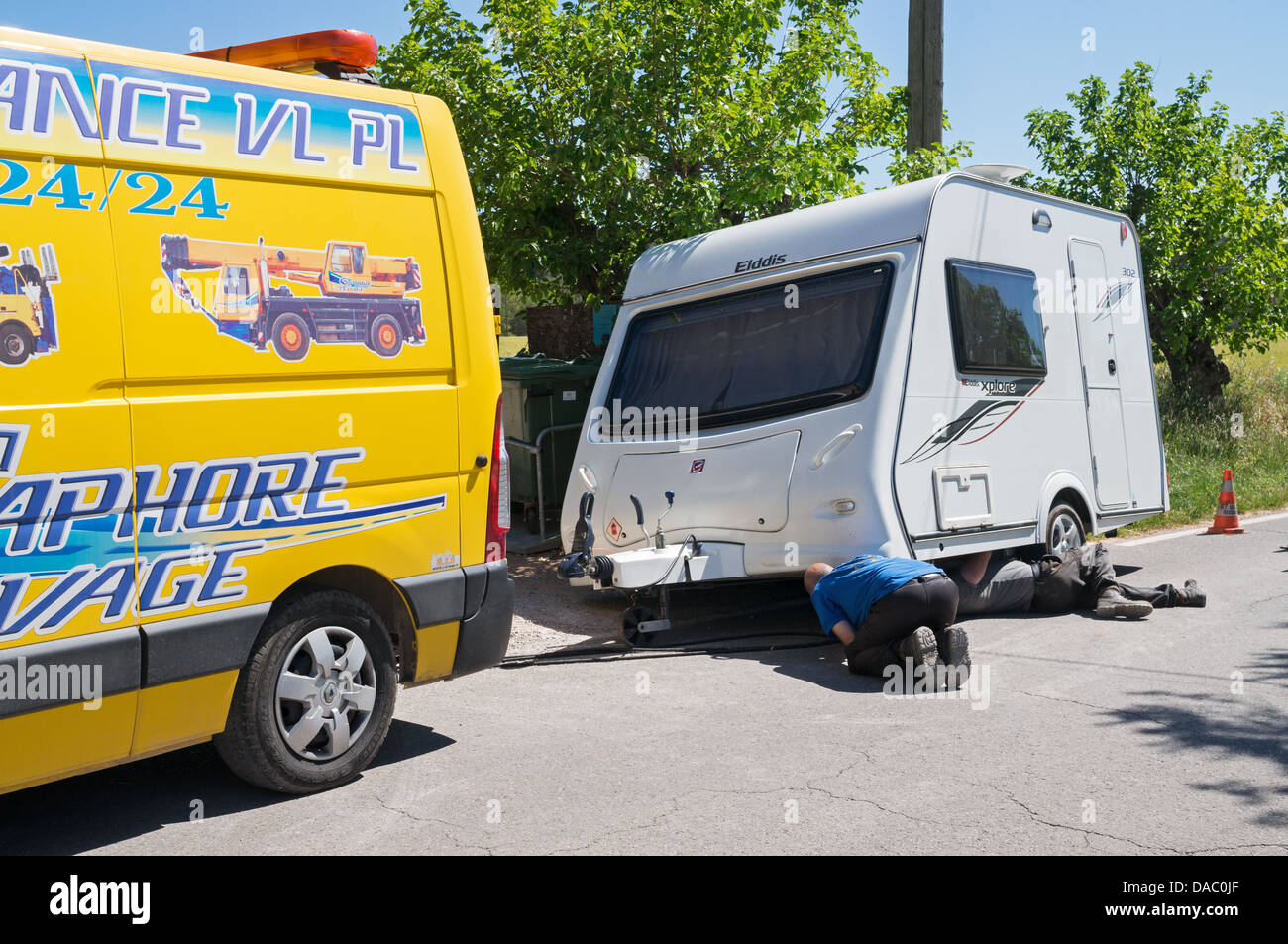 Caravane avec une roue bloquée dans un fossé lors d'une tournée en France. Une récupération professionnelle effet travailleurs sauvetage avec des sacs d'air. Banque D'Images