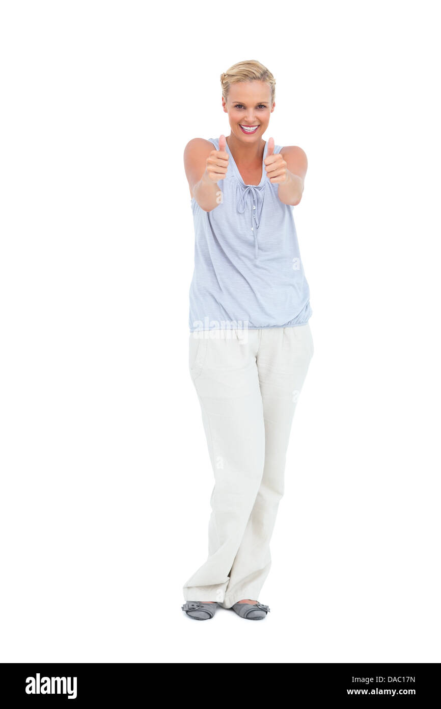 Happy woman standing with Thumbs up smiling at camera Banque D'Images