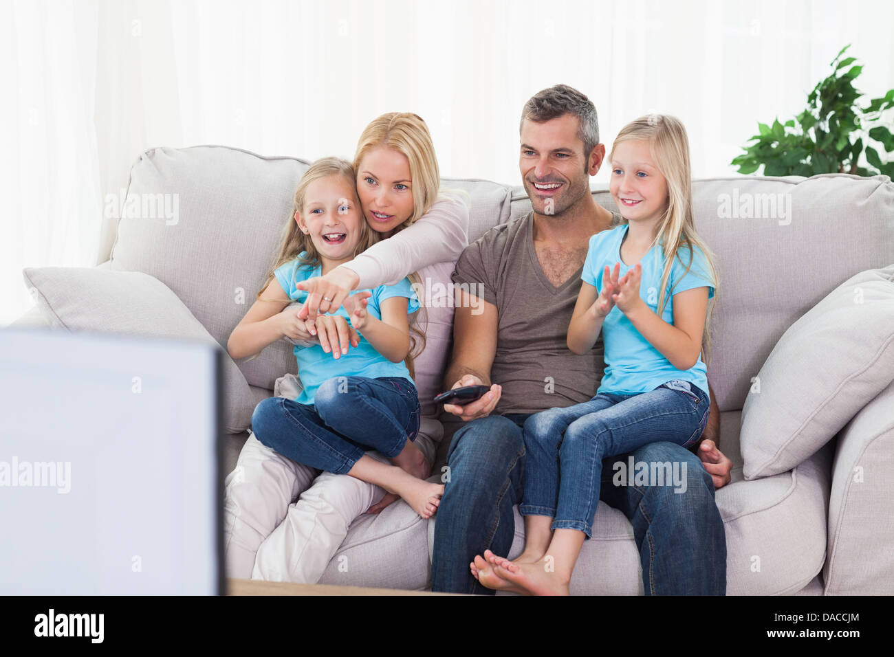 Cute twins et les parents à regarder la télévision Banque D'Images