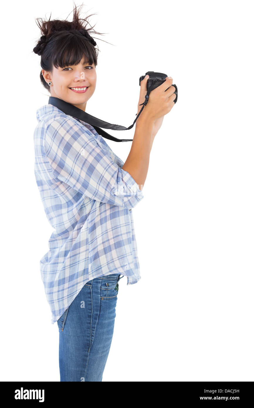 Smiling young woman taking photo avec son appareil photo Banque D'Images
