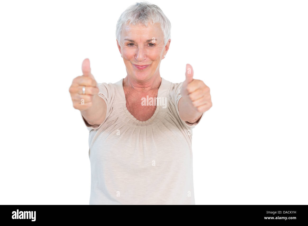 Young woman smiling at camera giving Thumbs up Banque D'Images
