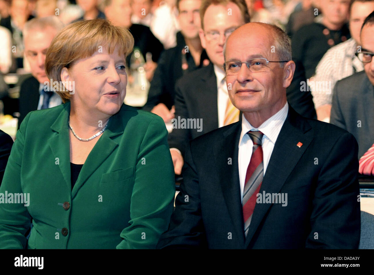 La chancelière allemande, Angela Merkel, s'assoit à côté de IG Metal président Berthold Huber lors d'une conférence de l'union de la métallurgie allemande IG Metall à Rheinstetten près de Karlsruhe, Allemagne, 14 octobre 2011. Photo : FRANZISKA KRAUFMANN Banque D'Images