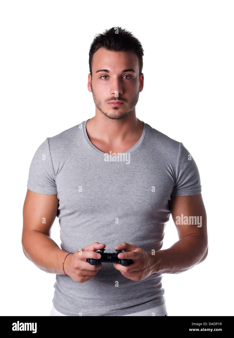 Jeune homme attrayant à l'aide du joystick ou joypad pour les jeux vidéo, isolated on white Banque D'Images