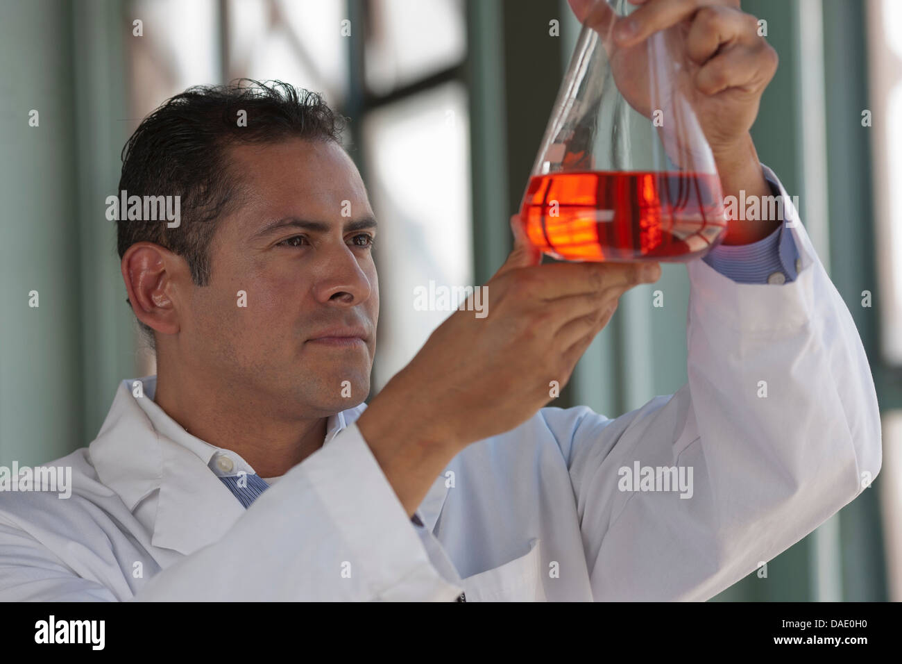 Mature scientist looking at liquid fiole en Banque D'Images