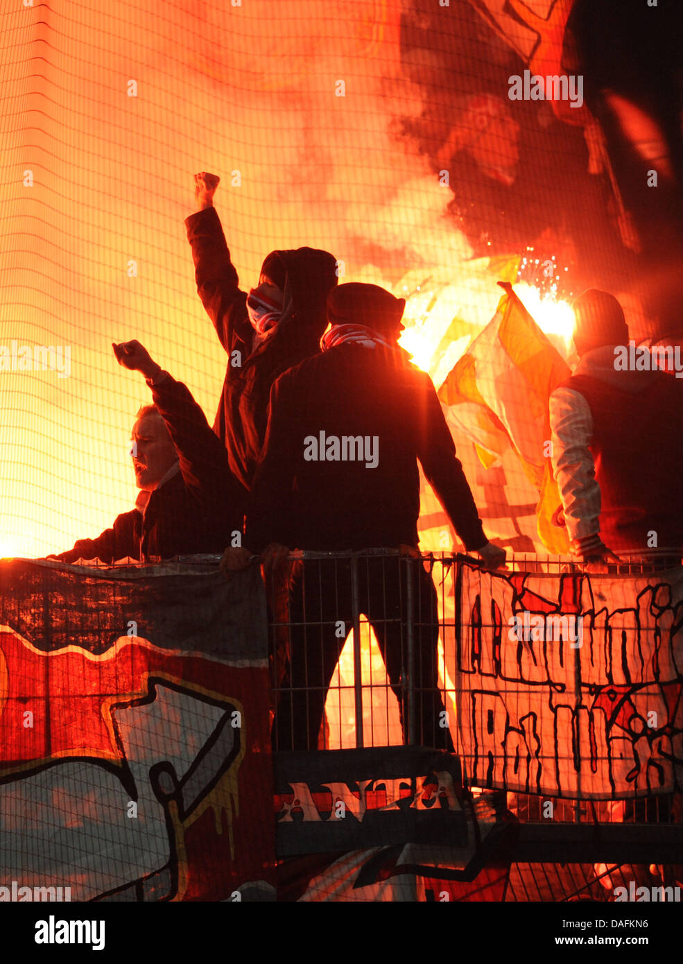 Mainz's fans utiliser des pièces pyrotechniques au cours de la Bundesliga match de foot VfL Wolfsburg vs 1. FSV Mainz 05 chez Volkswagen Arena de Wolfsburg, Allemagne, 03 décembre 2011. Photo : Peter Steffen Banque D'Images