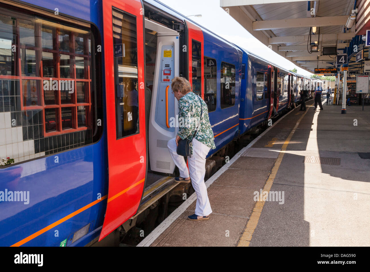 Une femme à bord d'un seul train Gare à Vauxhall, Londres, Angleterre, Royaume-Uni Banque D'Images