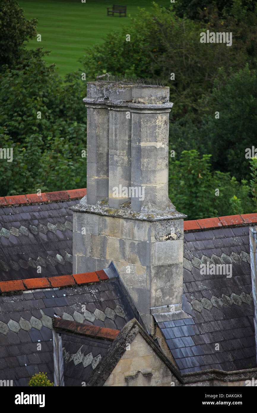Orné d'une cheminée en pierre au milieu d'un bain vieux toit. Banque D'Images