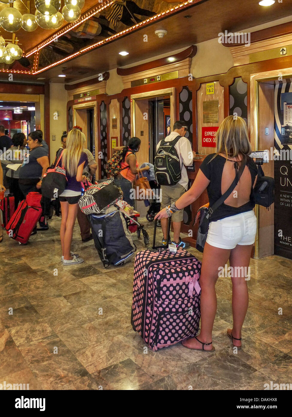 Les clients jeunes attendre l'ascenseur avec leurs bagages après vérification sur un Harrah's Hotel à Las Vegas, NV. Banque D'Images